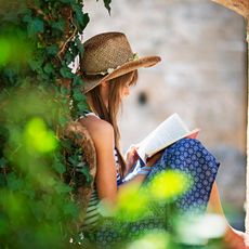 A girl reading a book outside