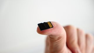 A microSD card on a fingertip