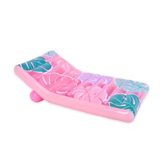 A pink pool lounger float with a palm leaf print