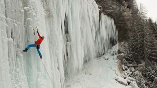 what is ice climbing: climber on frozen waterfall