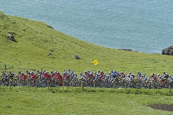 The peloton begin their climb beside Bass Strait in Stanley.