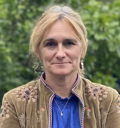 A headshot of a woman with blonde hair