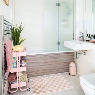 small bathroom with wood panelled bath and shower