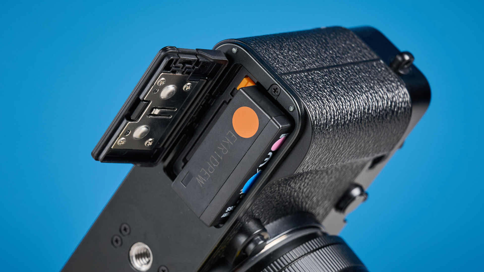 Fujifilm X-E5 battery against a blue background