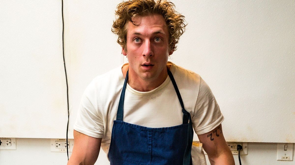 Actor Jeremy Allen White, who plays chef Carmen &#039;Carmy&#039; Berzatto in The Bear season 2, sits on a metal table in a hot kitchen.