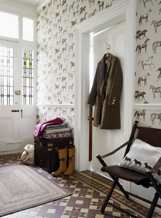 equestrian themed hallway, white horse / horses motif wallpaper with original feature decorative ceramic tiled flooring