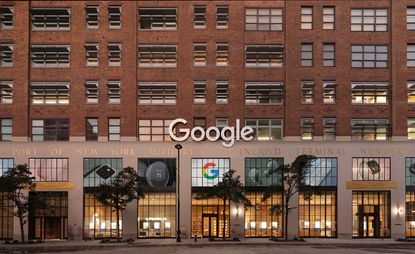 The façade of the Google New York store, featuring a brick facade and high windows facing the street. Google's logo is visible above the door