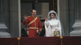 British equestrian Captain Mark Phillips and his wife, British Royal Princess Anne wave from the balcony of Buckingham Palace in Westminster, London, England, 14th November 1973. The couple were married in a ceremony at Westminster Abbey.