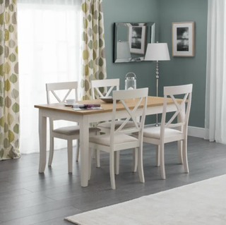 dining table and chair set in a dining room with pale green walls