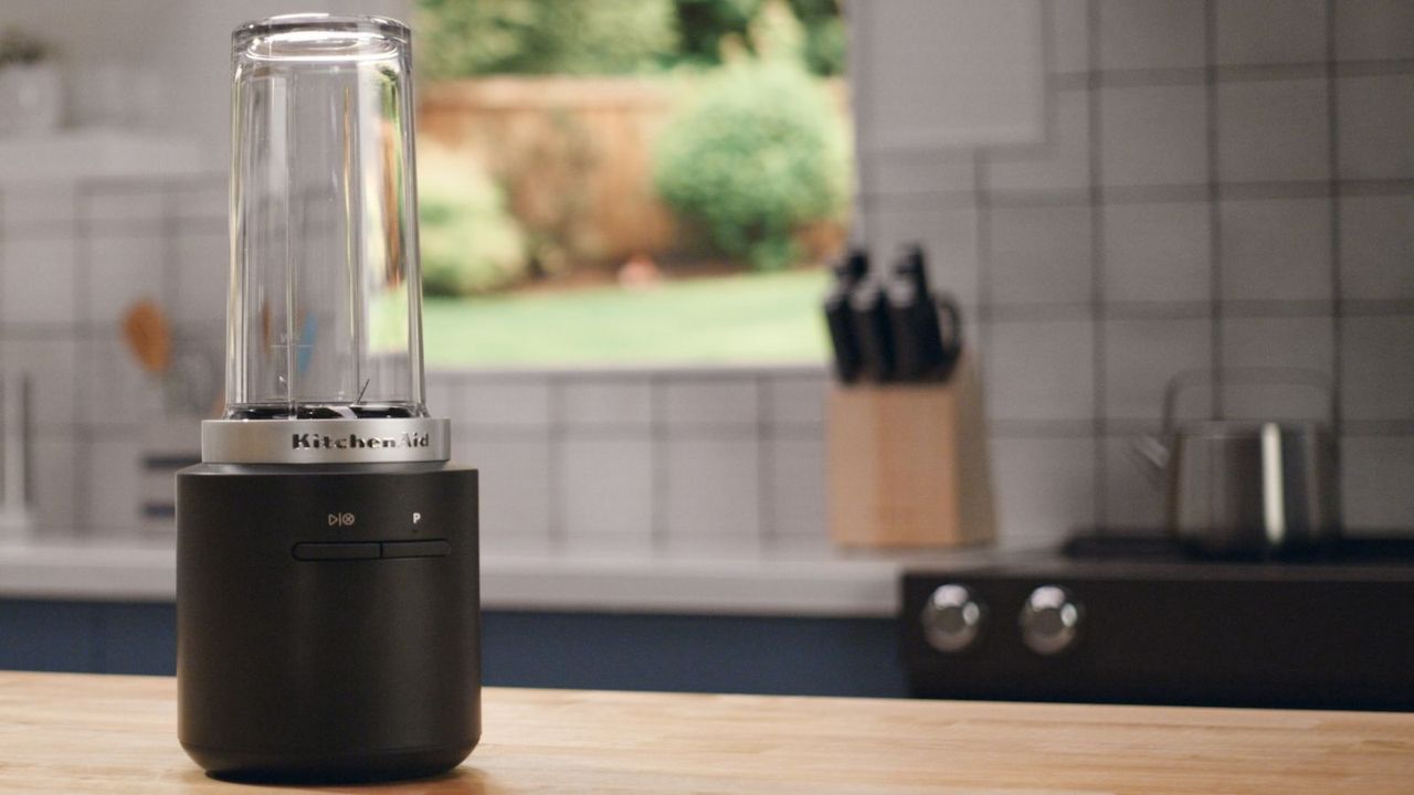 KitchenAid Go Cordless Portable Blender on a countertop with a kitchen in the background