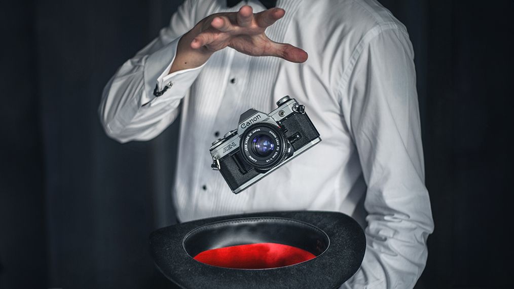 Magician making a Canon AE-1 appear out of a top hat