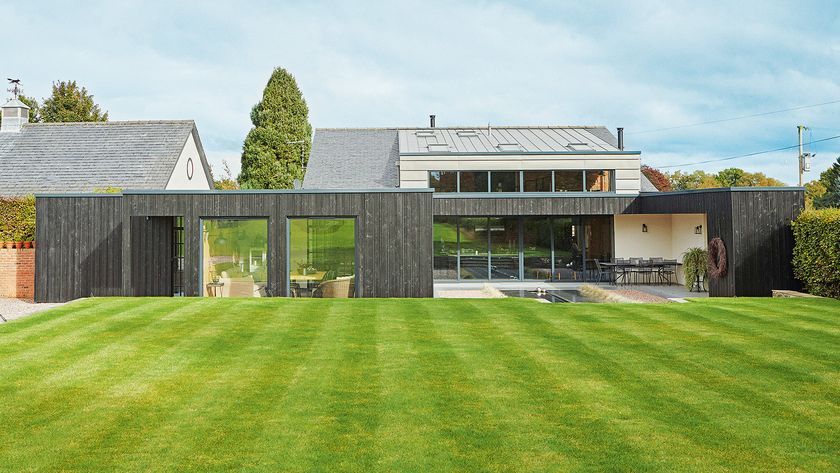 An expansive lush green lawn in front of a contemporary self-build home