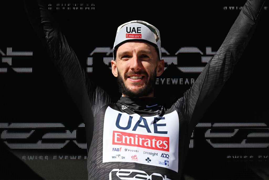 CARI SWITZERLAND JUNE 13 Adam Yates of The United Kingdom and UAE Team Emirates celebrates at podium as Black points jersey winner during the 87th Tour de Suisse 2024 Stage 5 a 1486km stage from Ambri to Cari 1636m UCIWT on June 13 2024 in Cari Switzerland Photo by Tim de WaeleGetty Images