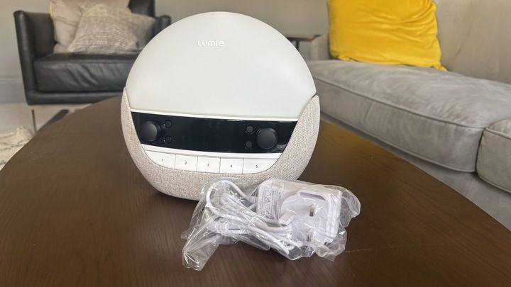 The Lumie Body clock 700FM Luxe freshly unpacked besides its accessories still in their plastic pacaging.