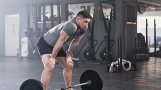 What is a deload week: man resting from his deadlift