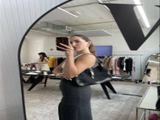 a selfie of editor Anna LaPlaca wearing a black vintage Gucci Jackie shoulder bag from Vestiaire Collective