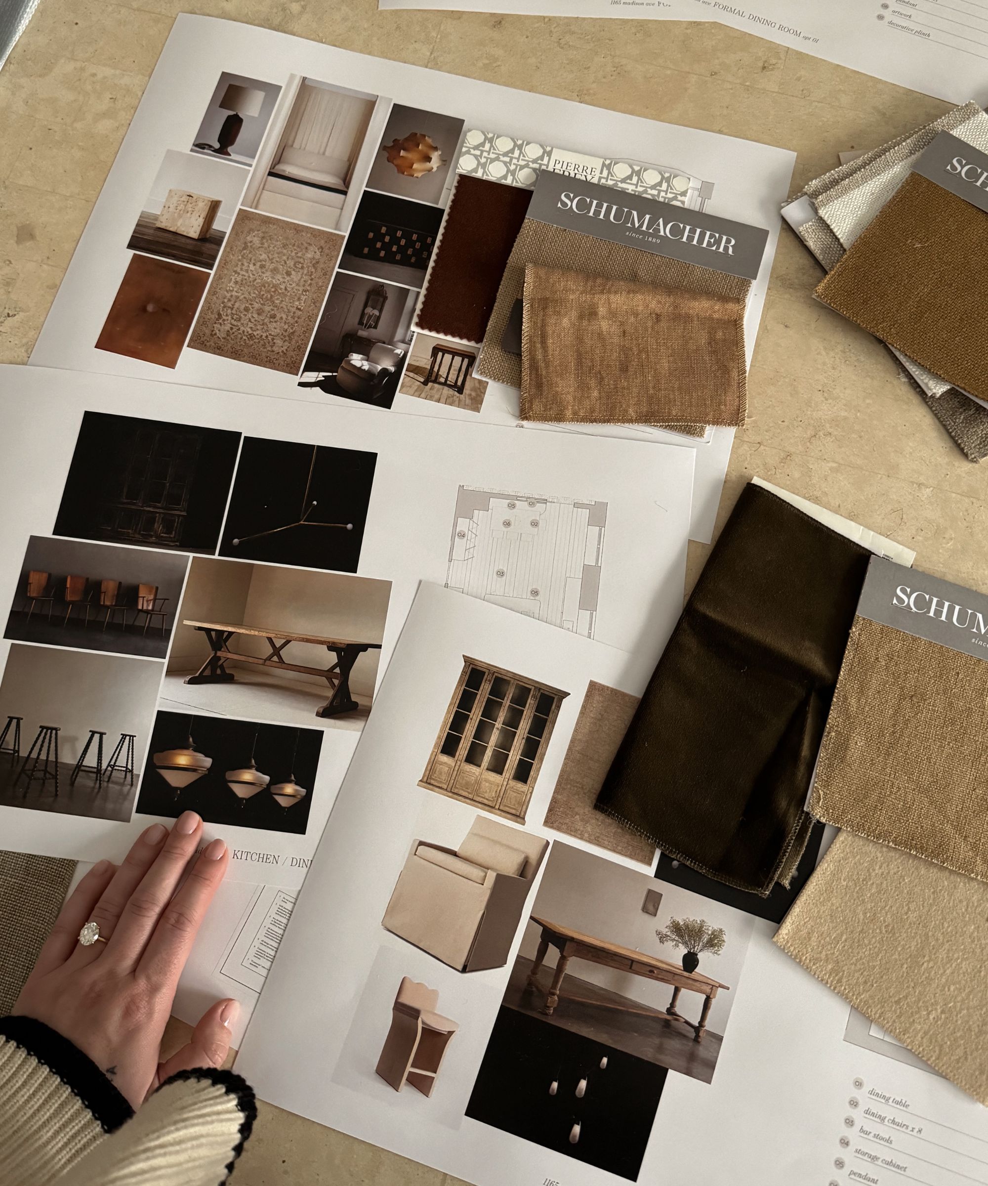 Close-up of an interior designer's moodboard, showing images of furniture, fabric samples, and room plans