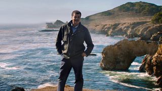 Astrophysicist Neil deGrasse Tyson stands at the sea in a scene from "Unafraid of the Dark," the final episode of "Cosmos: A Spacetime Odyssey."