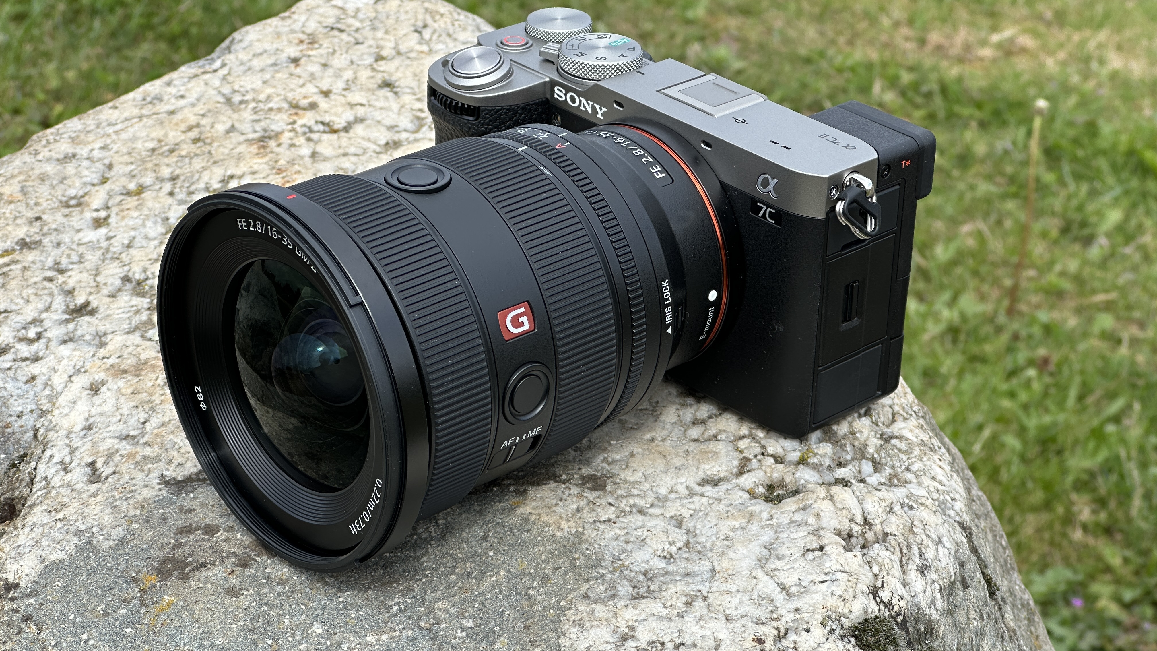 Sony A7C II mirrorless camera outside on a rock with Sony FE 16-35mm F2.8 GM II lens attached