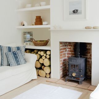 living room with white wall and couch and stove