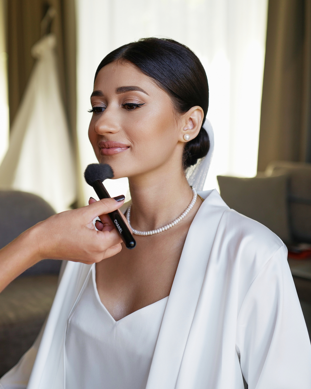 Woman having bridal make-up applied