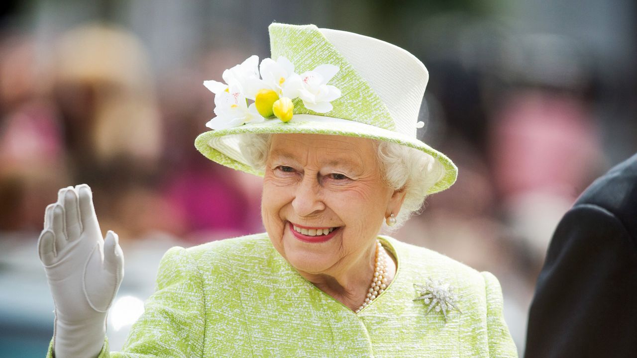 Queen Elizabeth II waves during a walk about around Windsor on her 90th Birthday on April 21, 2016 in Windsor, England