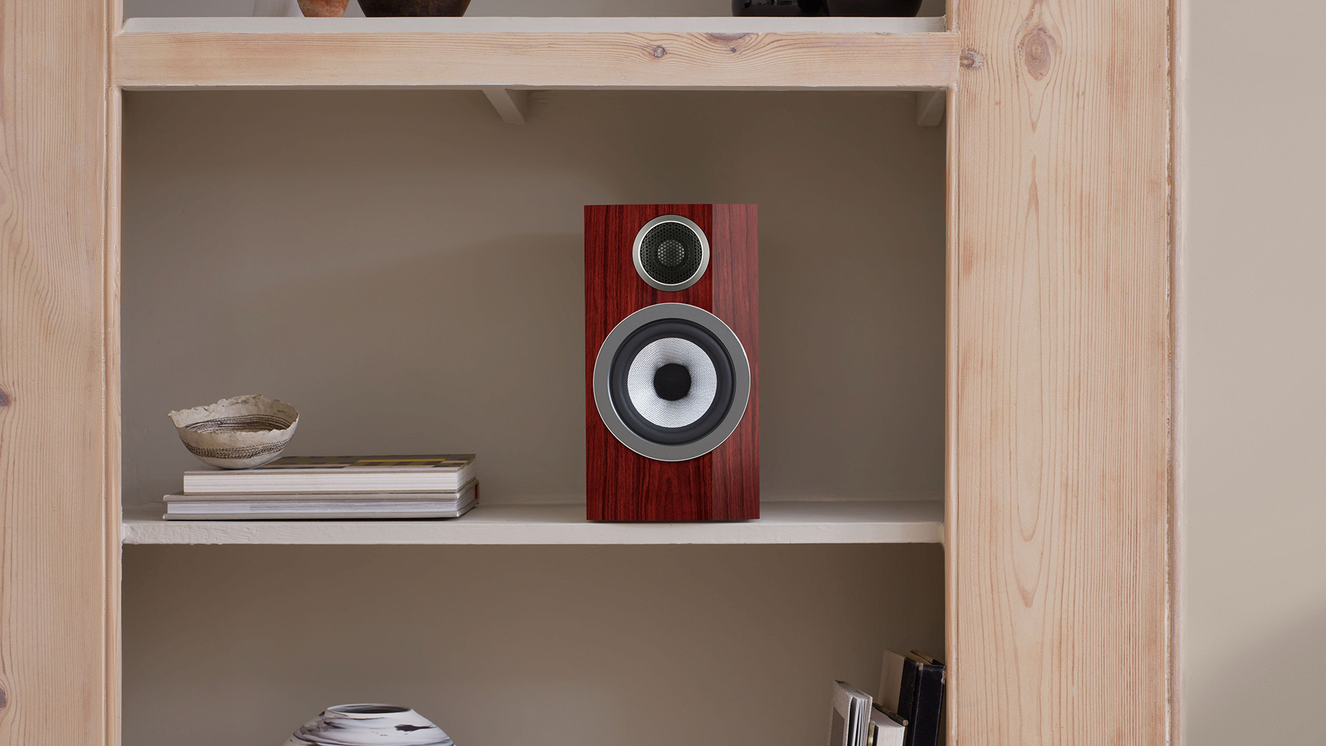 Bowers &amp;amp; Wilkins 707 Prestige Edition bookshelf speaker on a shelf