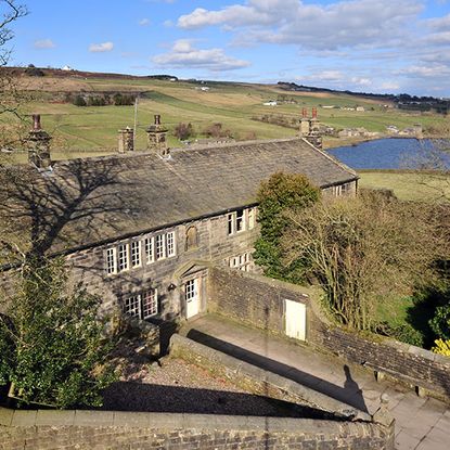 poden hall with stone wall white window near lake