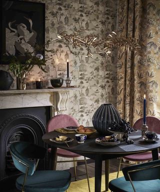 A colorful maximalist dining room with grey chinoiserie wallpaper