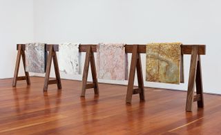 draped marble over wooden table in an art gallery