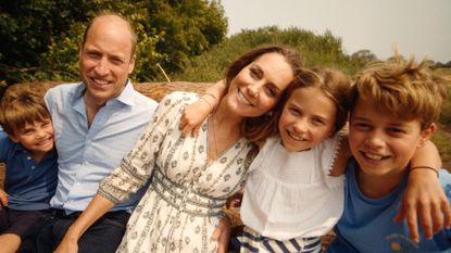 Kate Middleton poses with husband Prince William and their three smiling children Prince George, Princess Charlotte, and Prince Louis