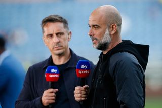 Pep Guardiola manager of Manchester City with Sky Sports pundit Gary Neville prior to the Premier League match between Burnley FC and Manchester City at Turf Moor on August 11, 2023 in Burnley, England.