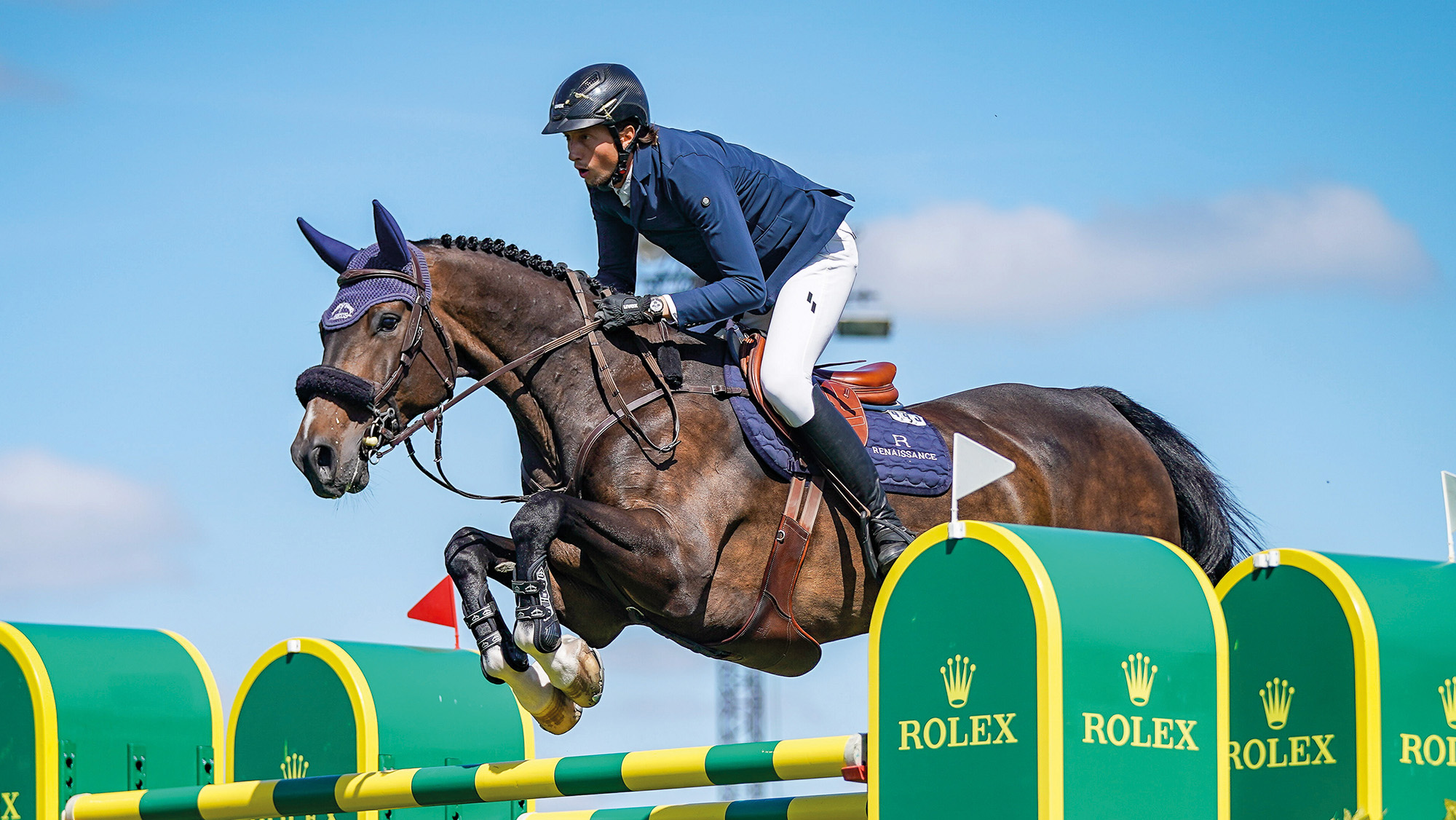 Close up of Martin Fuchs jumping Conner Jei