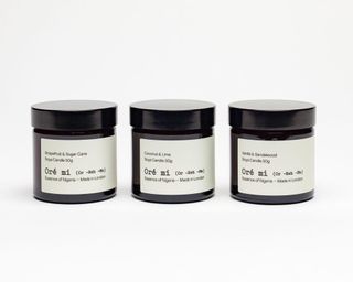 A trio of scented candles in black glass jars