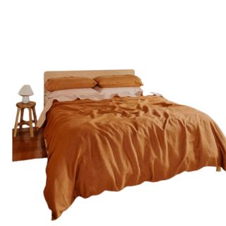 An orange and terracotta bedding set on a bed