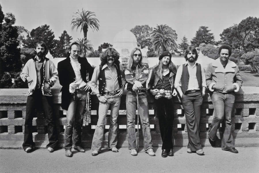 Doobie Brothers circa 1976, posing outside with palm trees in the background
