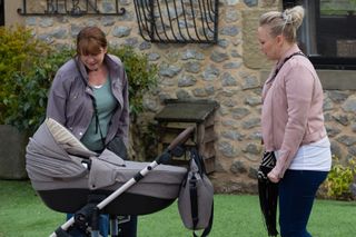 Tracy's not happy when Wendy touches baby Frankie.