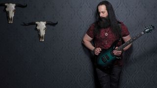 Petrucci at Guitar World HQ with a new six-string Enchanted Forest Ernie Ball Music Man Majesty