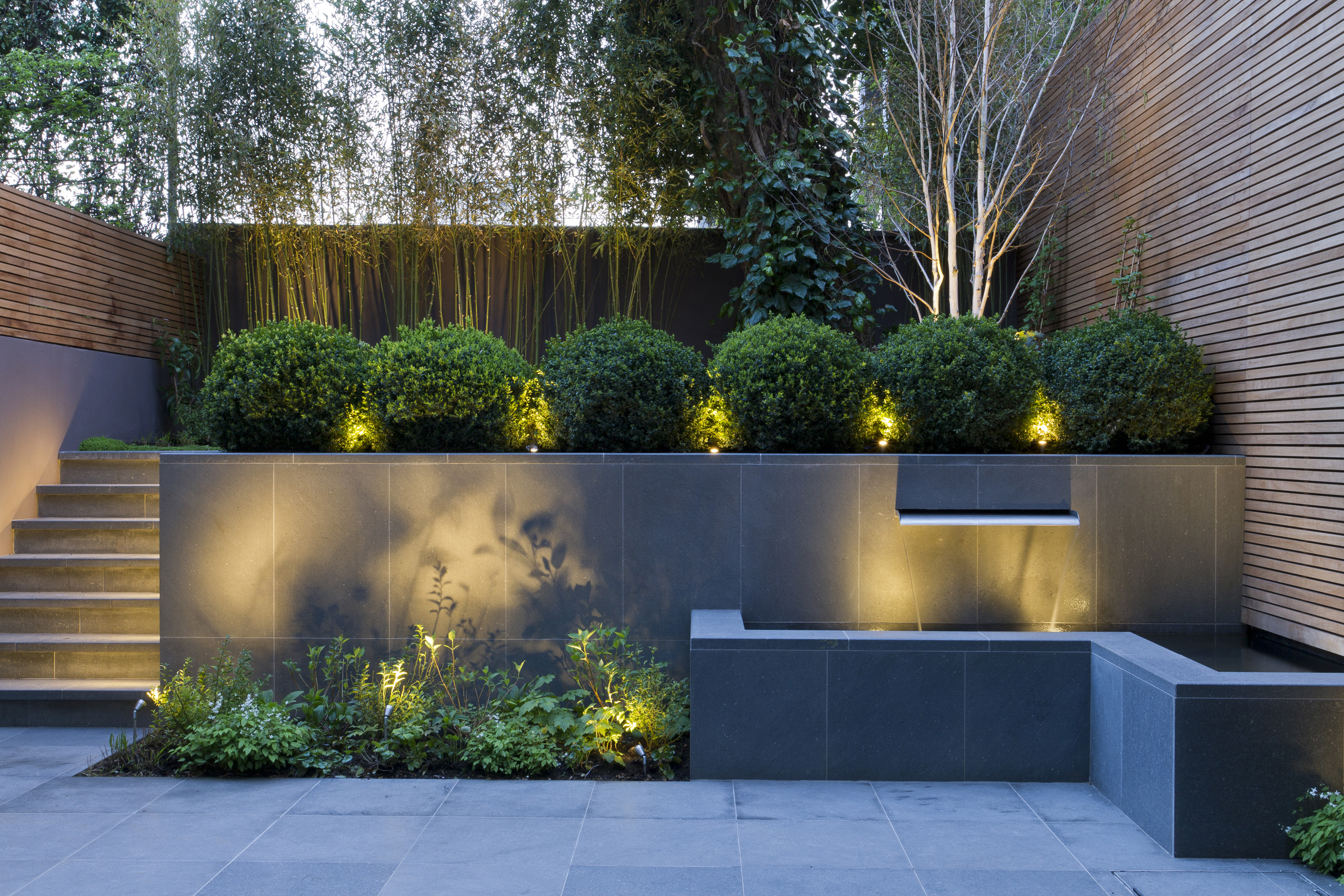 contemporary garden with sleek garden walls and water feature