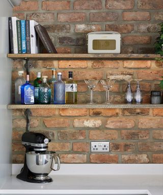 A open brick wall kitchen with wooden open shelves