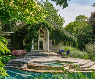 exterior of historic home with pool and steps and arched window