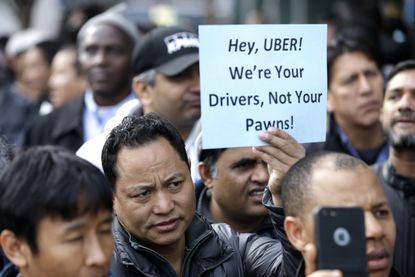 Uber drivers protest fare cuts.