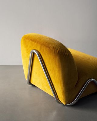 Part of a sofa by David and Nicolas for Tacchini, with metal upside down V shape on the back and yellow corduroy upholstery