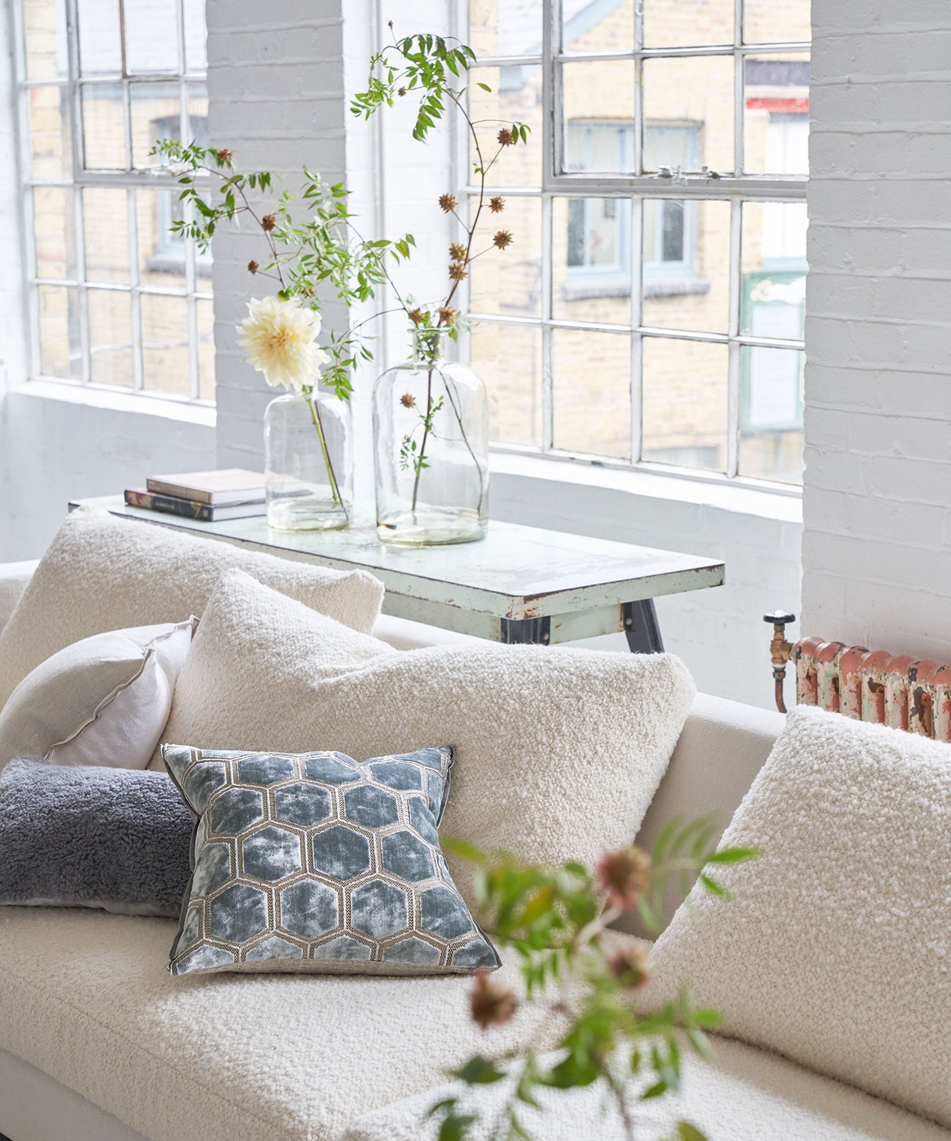 White sofa in white room with white console table