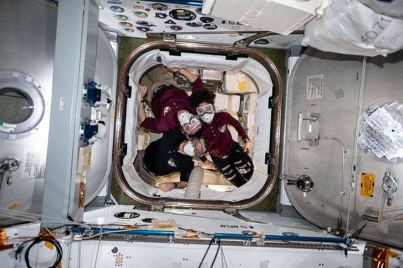 The crew of Expedition 62 to the International Space Station is pictured inside a SpaceX Dragon resupply craft, on March 9, 2020. They are wearing portable breathing gear while entering the spacecraft just in case there are any particles or irritants in the air that could have come loose while launching to space. (From top to bottom: NASA astronaut Andrew Morgan, Russian cosmonaut Oleg Skripochka and NASA astronaut Jessica Meir)