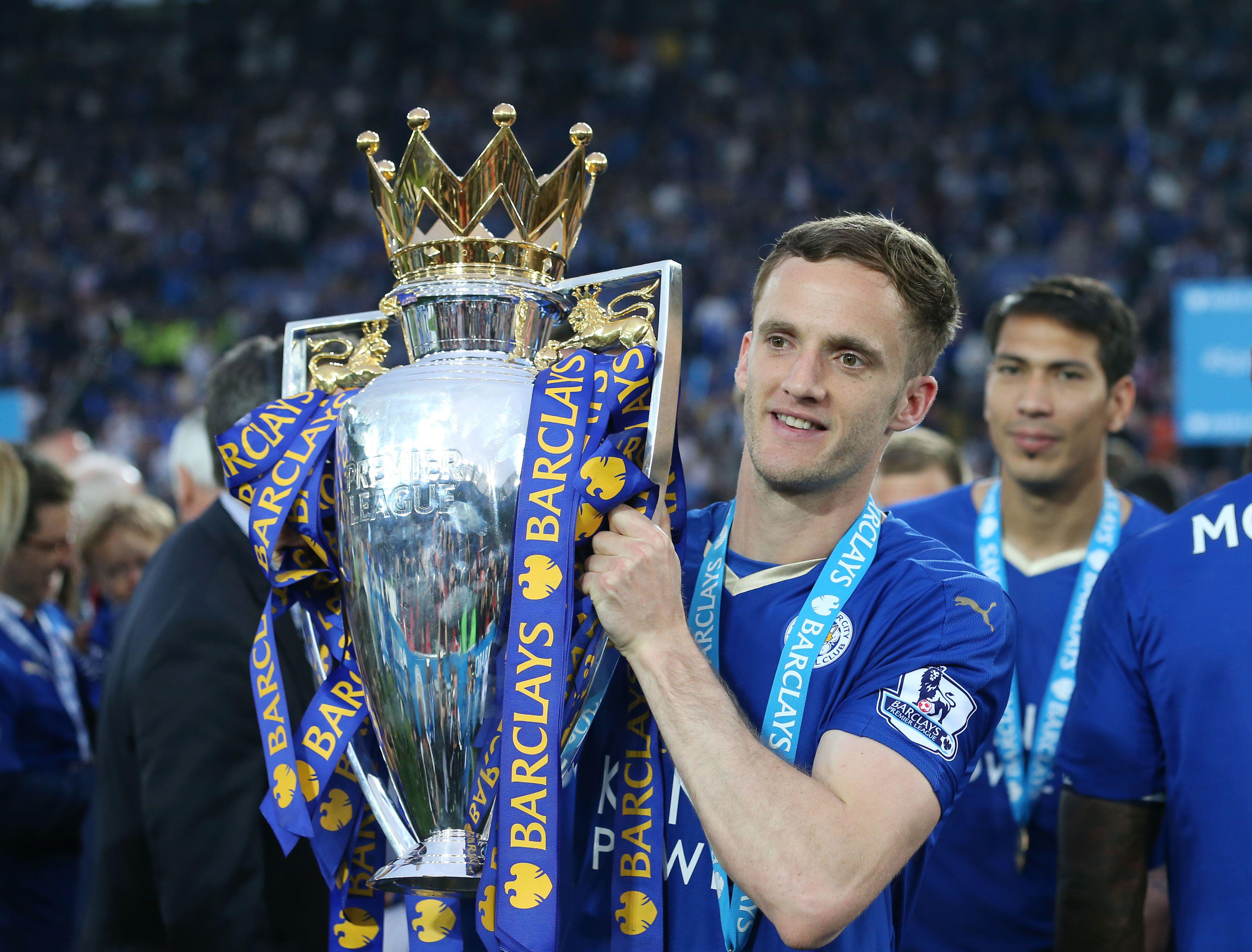 Leicester City's Andy King holds the Premier League trophy, 2016