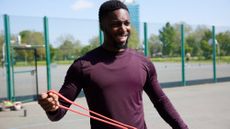 A man exercising with a resistance band 