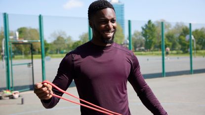 A man exercising with a resistance band 