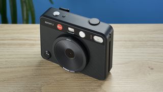 A black Leica Sofort 2 hybrid instant camera