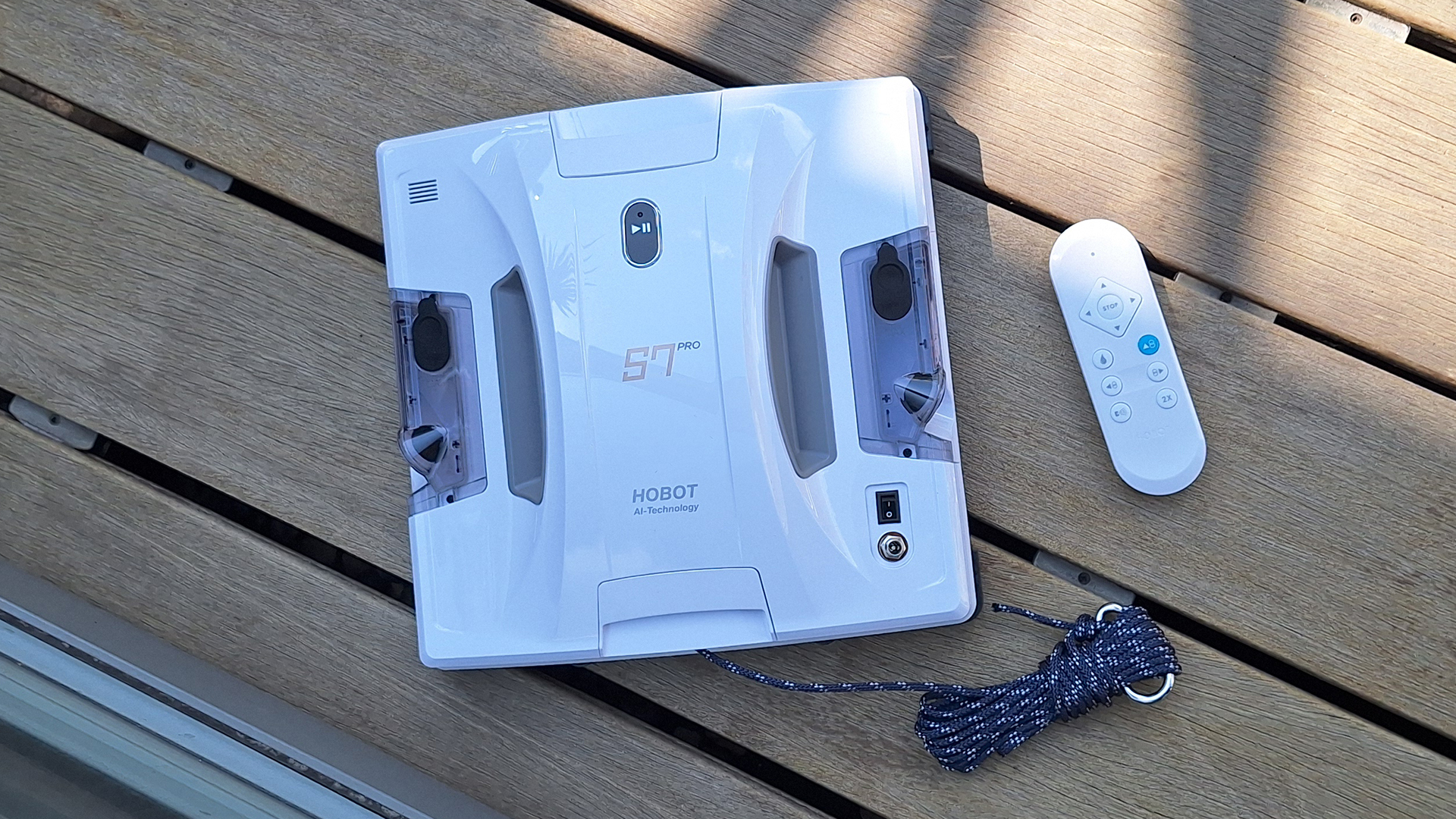 Hobot S7 Pro window cleaning robot on wooden deck next to patio doors